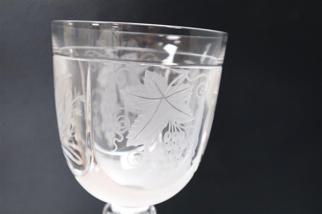 A wheel engraved glass goblet and two similar wine glasses, tallest 29cm